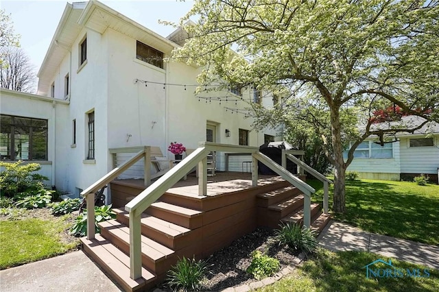 218 E Mcpherson Ave, Findlay, OH 45840 - back of house with a lawn and stucco siding