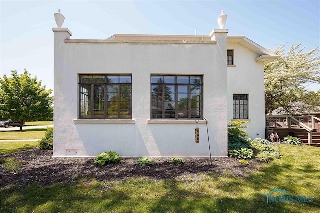 218 E Mcpherson Ave, Findlay, OH 45840 - view of side of home with stucco siding and a yard