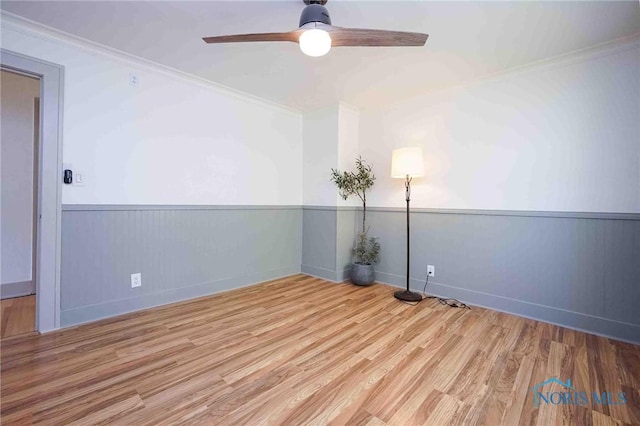 218 E Mcpherson Ave, Findlay, OH 45840 - spare room featuring a ceiling fan, crown molding, wood finished floors, wainscoting, and baseboards
