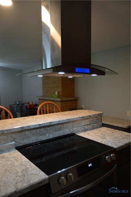 309 Huron Rd, Findlay, OH 45840 - kitchen featuring range with electric cooktop, exhaust hood, and light countertops