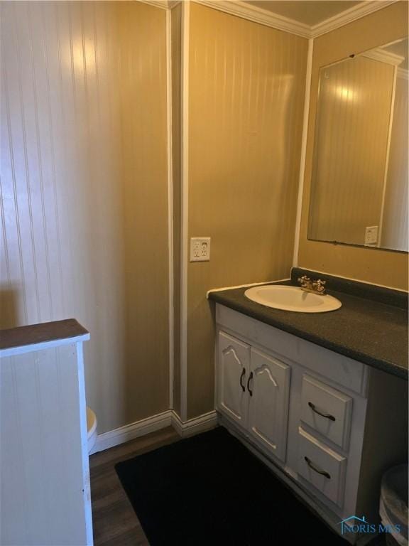 1001 Sunday St, Defiance, OH 43512 - bathroom with toilet, vanity, ornamental molding, wood finished floors, and baseboards
