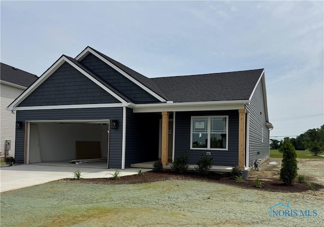 1902 Caleb Ct, Waterville, OH 43566 - view of front facade with concrete driveway, an attached garage, and covered porch