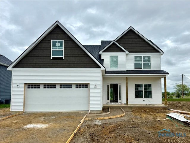 1938 Caleb Ct, Waterville, OH 43566 - view of front facade with a garage, driveway, and central AC