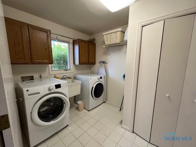 6047 Peppermill Dr, Sylvania, OH 43560 - clothes washing area with cabinet space, washer and clothes dryer, light tile patterned floors, and baseboards