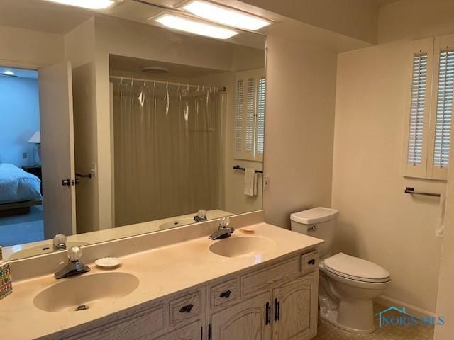 6047 Peppermill Dr, Sylvania, OH 43560 - bathroom featuring toilet, double vanity, and connected bathroom