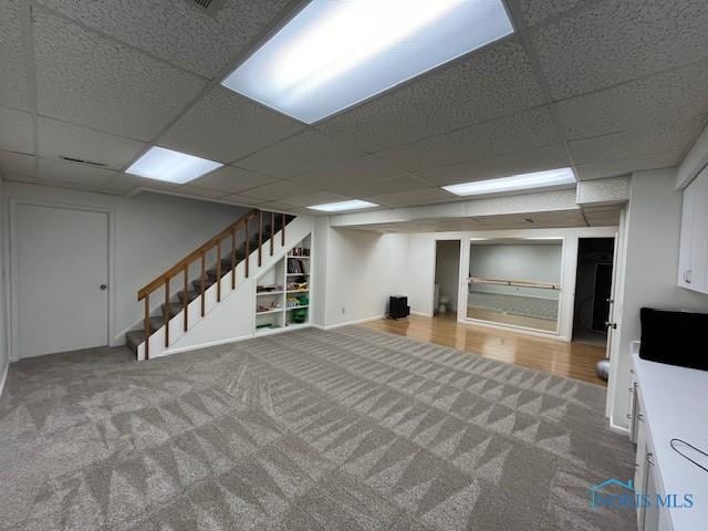 6047 Peppermill Dr, Sylvania, OH 43560 - finished basement with a paneled ceiling, carpet flooring, and stairway