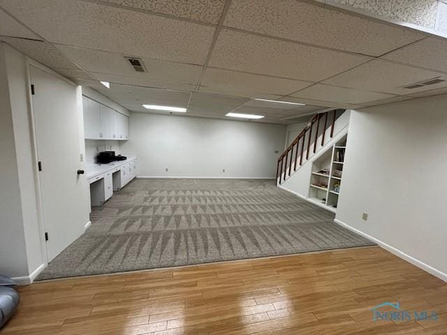 6047 Peppermill Dr, Sylvania, OH 43560 - finished below grade area with stairs, baseboards, light wood-style floors, and a drop ceiling