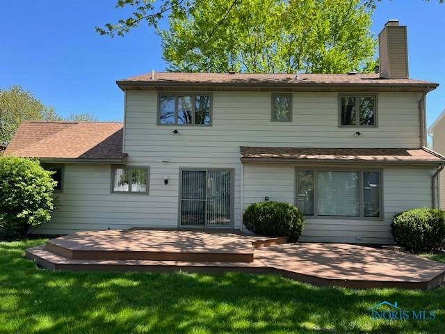 6047 Peppermill Dr, Sylvania, OH 43560 - back of house featuring a chimney, a wooden deck, a yard, and roof with shingles