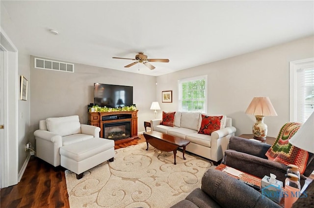 805 N Hill Trl, Findlay, OH 45840 - living area with ceiling fan, dark wood finished floors, a glass covered fireplace, and baseboards