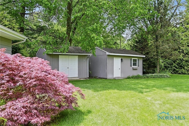 125 Carolin Ct, Perrysburg, OH 43551 - view of green lawn with a storage shed and an outbuilding