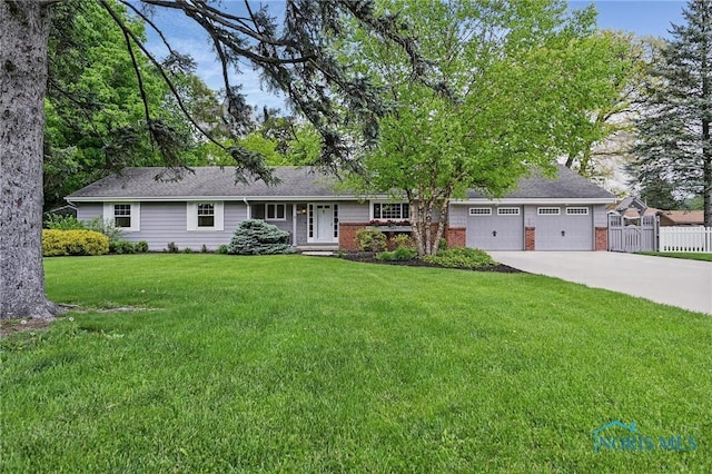 125 Carolin Ct, Perrysburg, OH 43551 - ranch-style home with concrete driveway, an attached garage, and brick siding