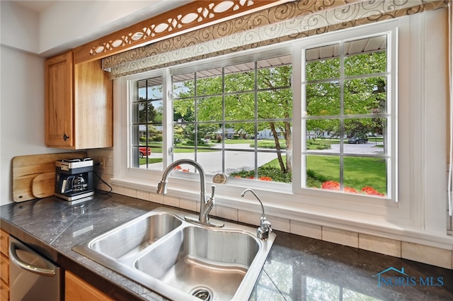 125 Carolin Ct, Perrysburg, OH 43551 - kitchen with a sink, tasteful backsplash, dark countertops, brown cabinets, and stainless steel dishwasher