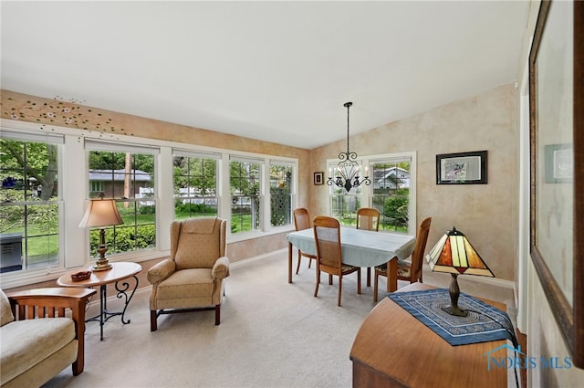 125 Carolin Ct, Perrysburg, OH 43551 - dining area with a chandelier, light carpet, lofted ceiling, and baseboards