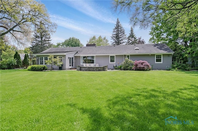 125 Carolin Ct, Perrysburg, OH 43551 - back of property with a lawn and a chimney