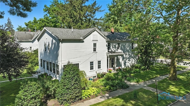 232 E Wayne St, Maumee, OH 43537 - view of home's exterior featuring a chimney, a lawn, and a shingled roof