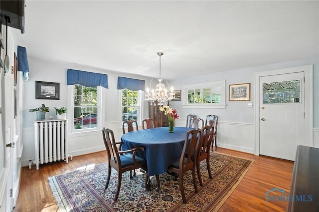 232 E Wayne St, Maumee, OH 43537 - dining room featuring a chandelier, radiator heating unit, and wood finished floors