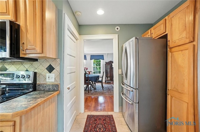 232 E Wayne St, Maumee, OH 43537 - kitchen featuring stainless steel appliances, backsplash, dark countertops, and light tile patterned flooring