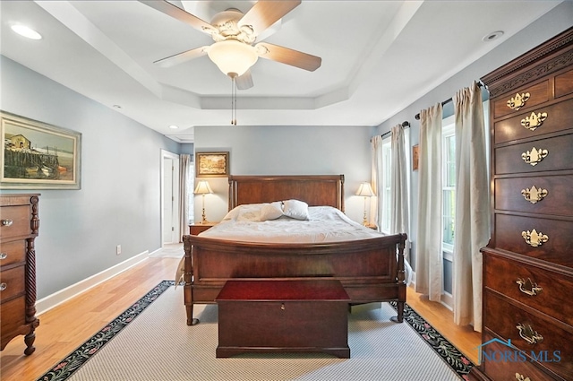232 E Wayne St, Maumee, OH 43537 - bedroom featuring a tray ceiling, light wood-type flooring, recessed lighting, and a ceiling fan