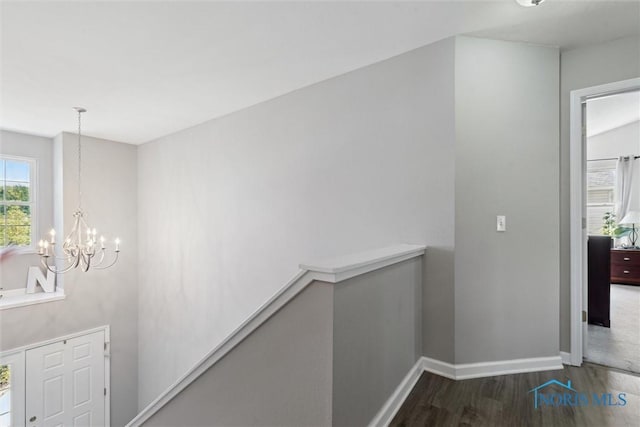 548 Niagara Ave, Holland, OH 43528 - corridor with a chandelier, wood finished floors, baseboards, and an upstairs landing