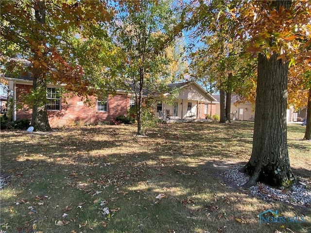 40 Lemans Dr, Napoleon, OH 43545 - view of front of house featuring a front yard and brick siding