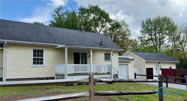 2659 Oak Grove Pl, Toledo, OH 43613 - view of front of property with a chimney, covered porch, an outdoor structure, a garage, and a shingled roof