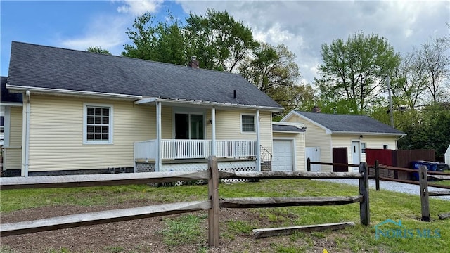 2659 Oak Grove Pl, Toledo, OH 43613 - view of front of house with an outbuilding, a chimney, a garage, and roof with shingles