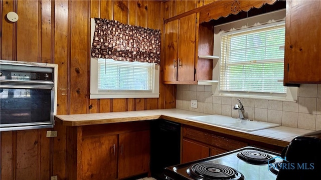 2659 Oak Grove Pl, Toledo, OH 43613 - kitchen featuring black appliances, tile countertops, a sink, backsplash, and brown cabinetry