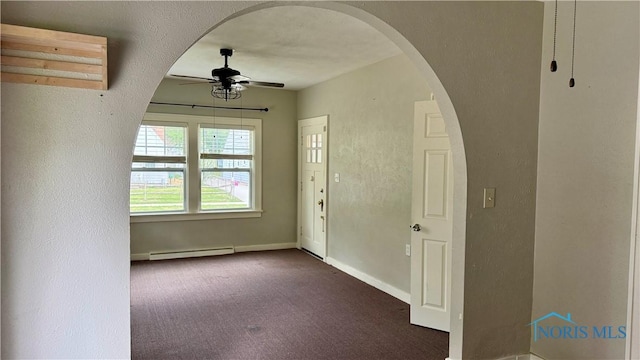 2659 Oak Grove Pl, Toledo, OH 43613 - foyer with a baseboard heating unit, a ceiling fan, dark carpet, arched walkways, and baseboards