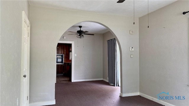 2659 Oak Grove Pl, Toledo, OH 43613 - carpeted empty room with a ceiling fan, arched walkways, and baseboards