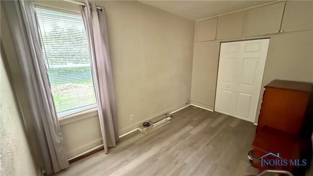 2659 Oak Grove Pl, Toledo, OH 43613 - unfurnished bedroom with light wood finished floors, a closet, and baseboards