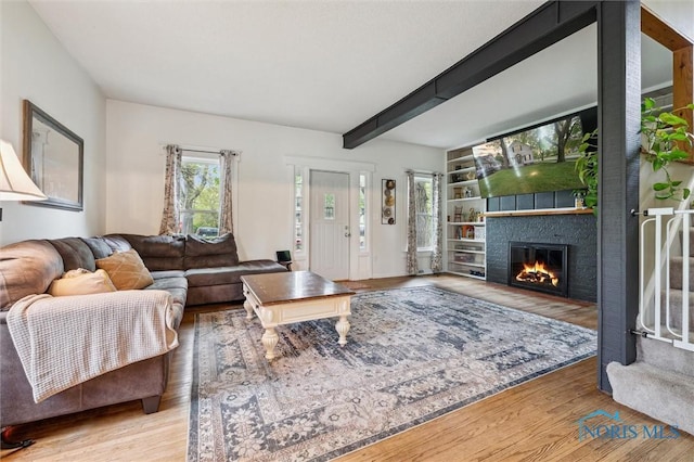 3555 Island Ave, Toledo, OH 43614 - living area with a fireplace, wood finished floors, and beam ceiling