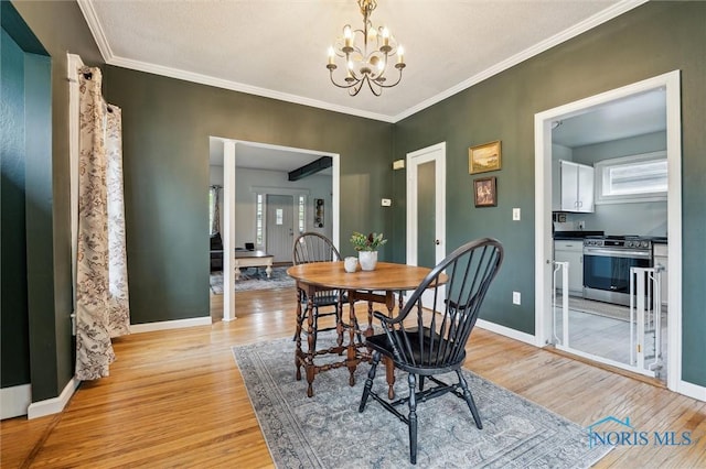 3555 Island Ave, Toledo, OH 43614 - dining area featuring light wood-type flooring, a chandelier, baseboards, and crown molding
