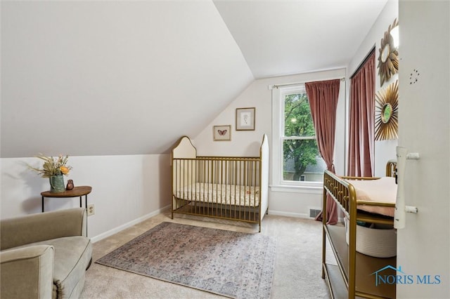 3555 Island Ave, Toledo, OH 43614 - carpeted bedroom featuring vaulted ceiling, baseboards, and a nursery area