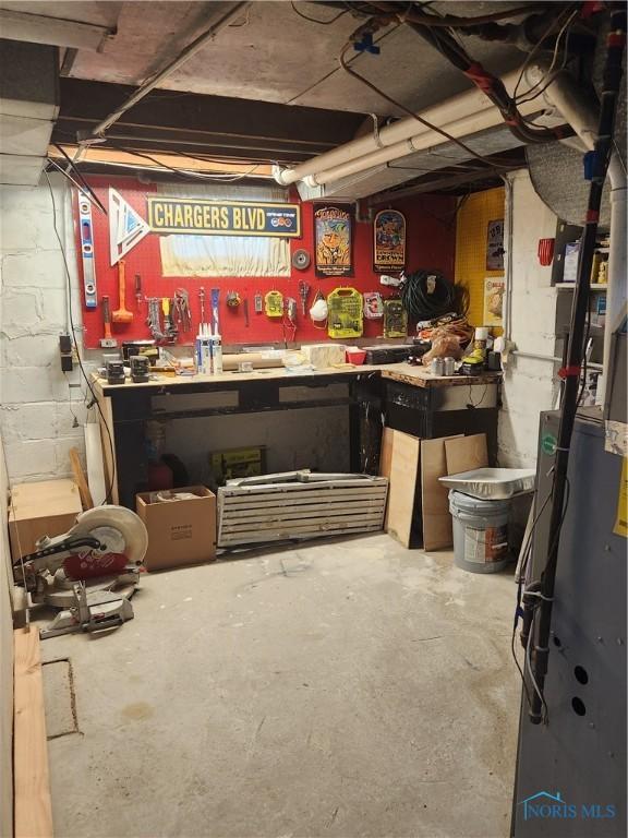 3555 Island Ave, Toledo, OH 43614 - unfinished basement featuring a workshop area and concrete block wall