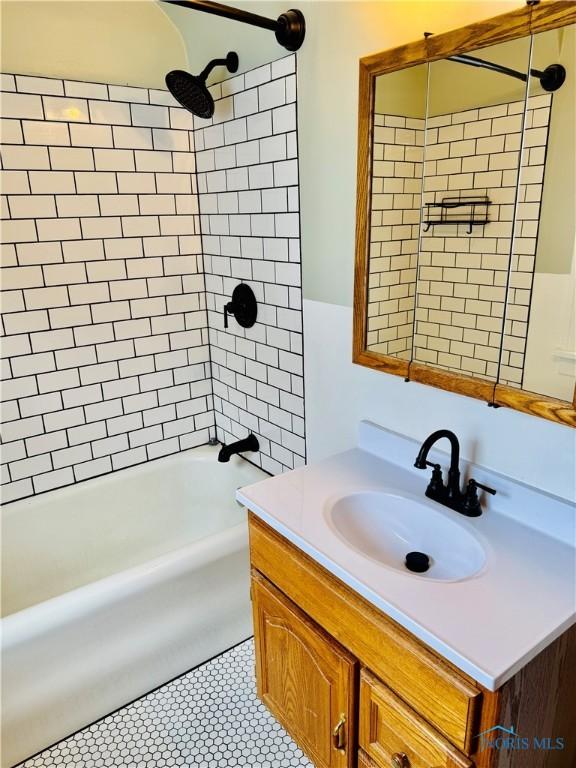full bathroom featuring vanity and  shower combination