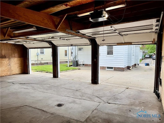 garage featuring a garage door opener and cooling unit