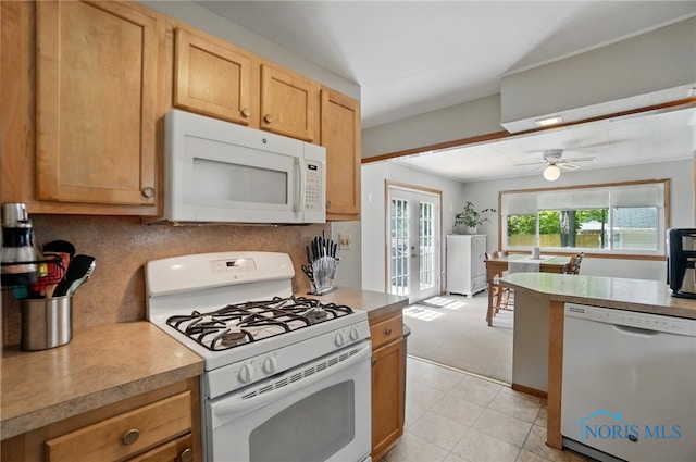 kitchen with white appliances, french doors, backsplash, a ceiling fan, and light countertops