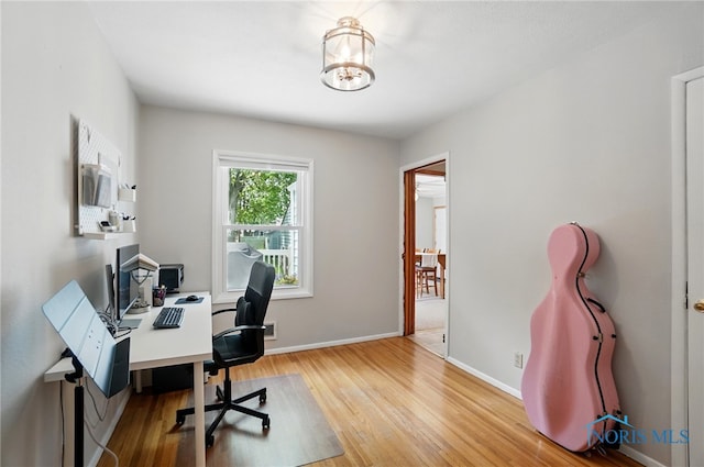 office with wood finished floors and baseboards