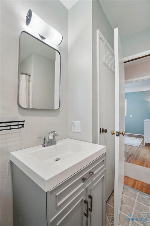 bathroom with vanity and wood finished floors