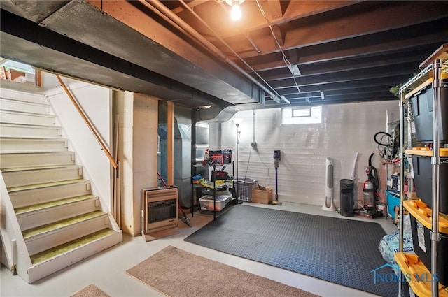 basement with heating unit and stairs