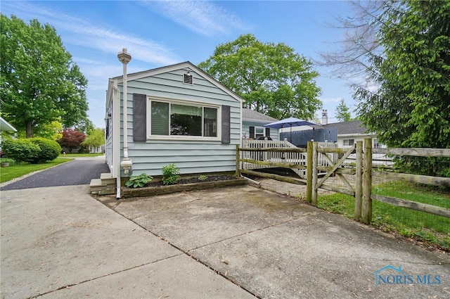 view of front of home featuring fence