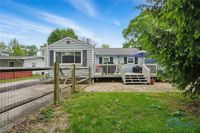 back of property featuring a wooden deck