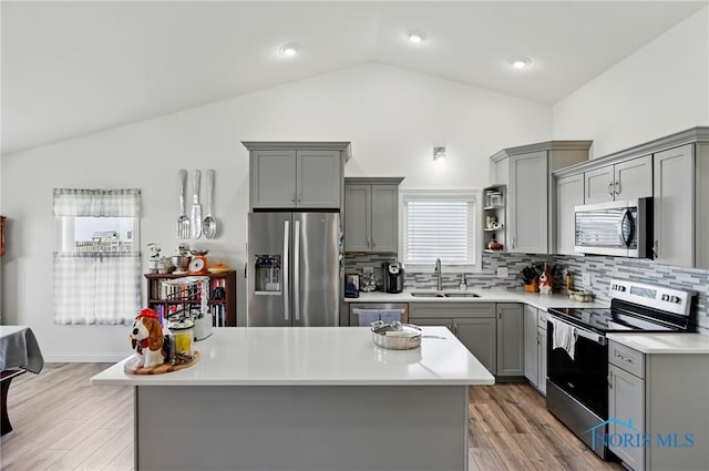 9274 Shaffer St, Findlay, OH 45840 - kitchen featuring stainless steel appliances, gray cabinetry, lofted ceiling, a sink, and light countertops