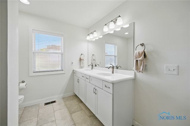 9274 Shaffer St, Findlay, OH 45840 - bathroom featuring toilet, double vanity, baseboards, and tile patterned flooring