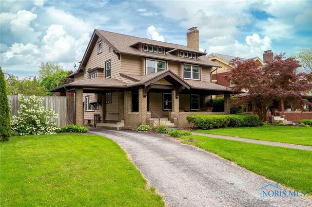 1211 S Main St, Findlay, OH 45840 - view of front of home with a chimney, asphalt driveway, covered porch, and brick siding