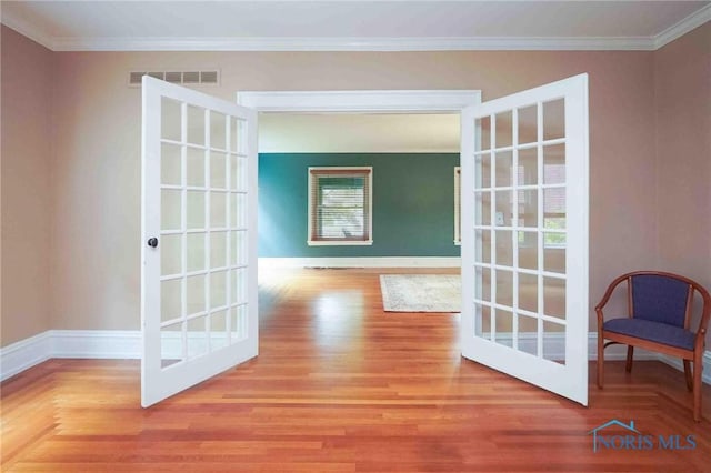 1211 S Main St, Findlay, OH 45840 - hall with crown molding, wood finished floors, baseboards, and french doors