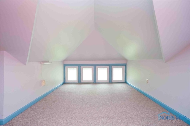 1211 S Main St, Findlay, OH 45840 - additional living space with vaulted ceiling, baseboards, and carpet floors