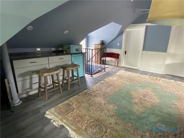 bonus room featuring dark wood finished floors and vaulted ceiling