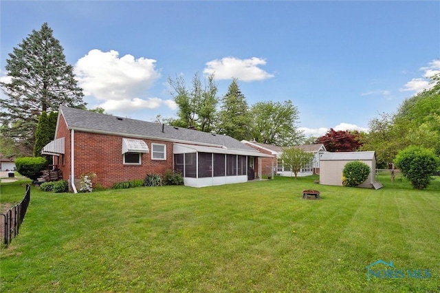 3333 Heatherdowns Blvd, Toledo, OH 43614 - rear view of property with a sunroom, a fire pit, and brick siding