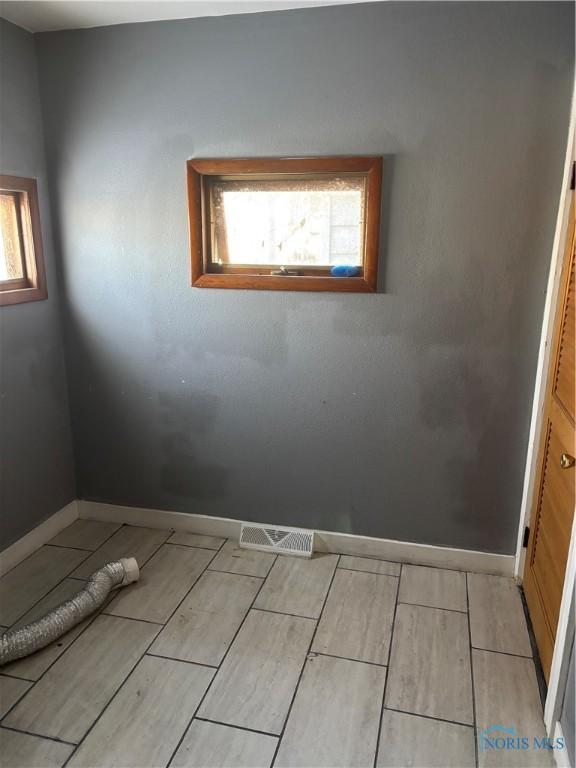 315 Austin St, Toledo, OH 43608 - empty room with wood tiled floors